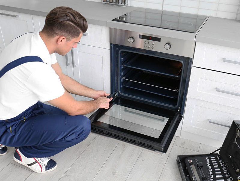 technican worker is repairing the bosch oven in the house