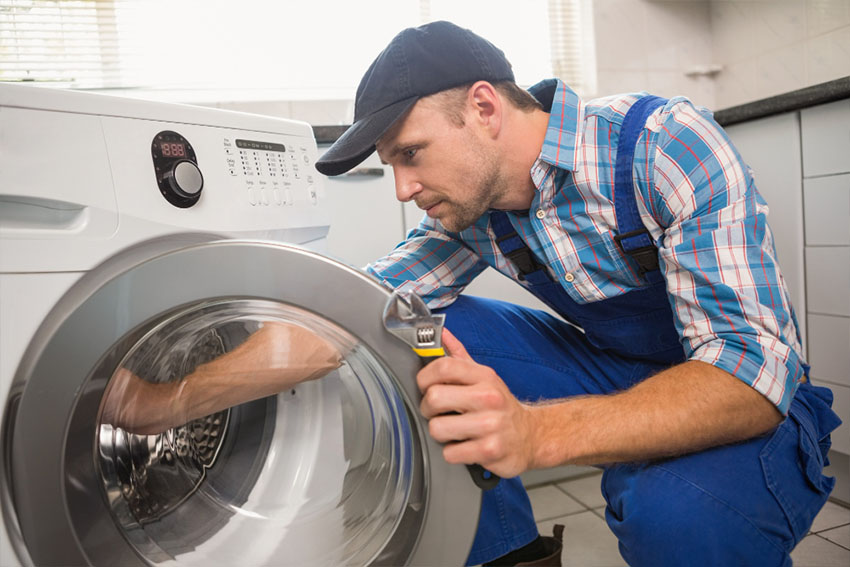 LG Washing mashine is getting repair by handyman in bathroom