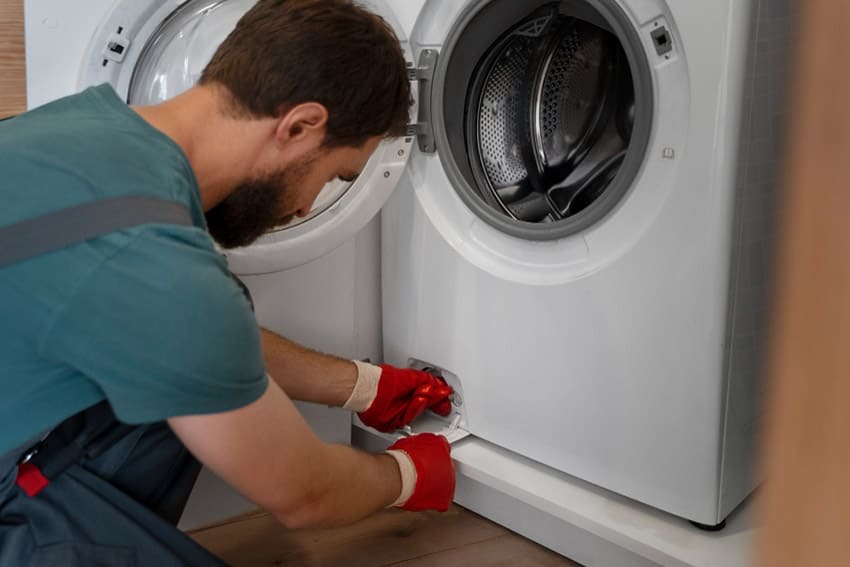 Handyman is fixing a Miele Washing Machine