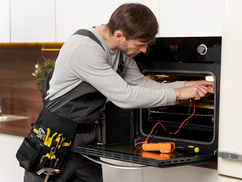 Service maintenance worker repairing Westinghouse oven in the kitchen